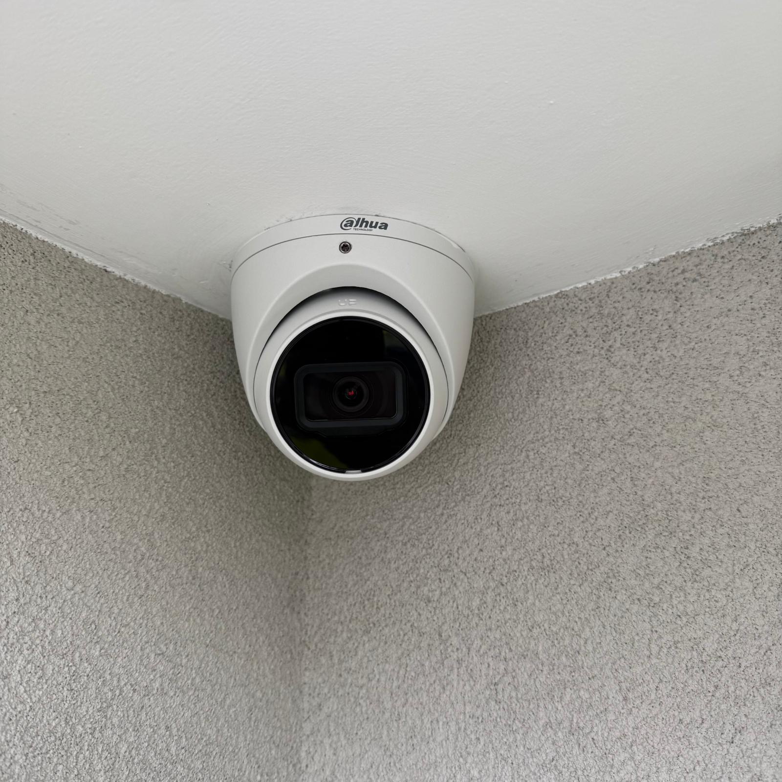 CCTV dome camera mounted on a modern Perth home at dusk
